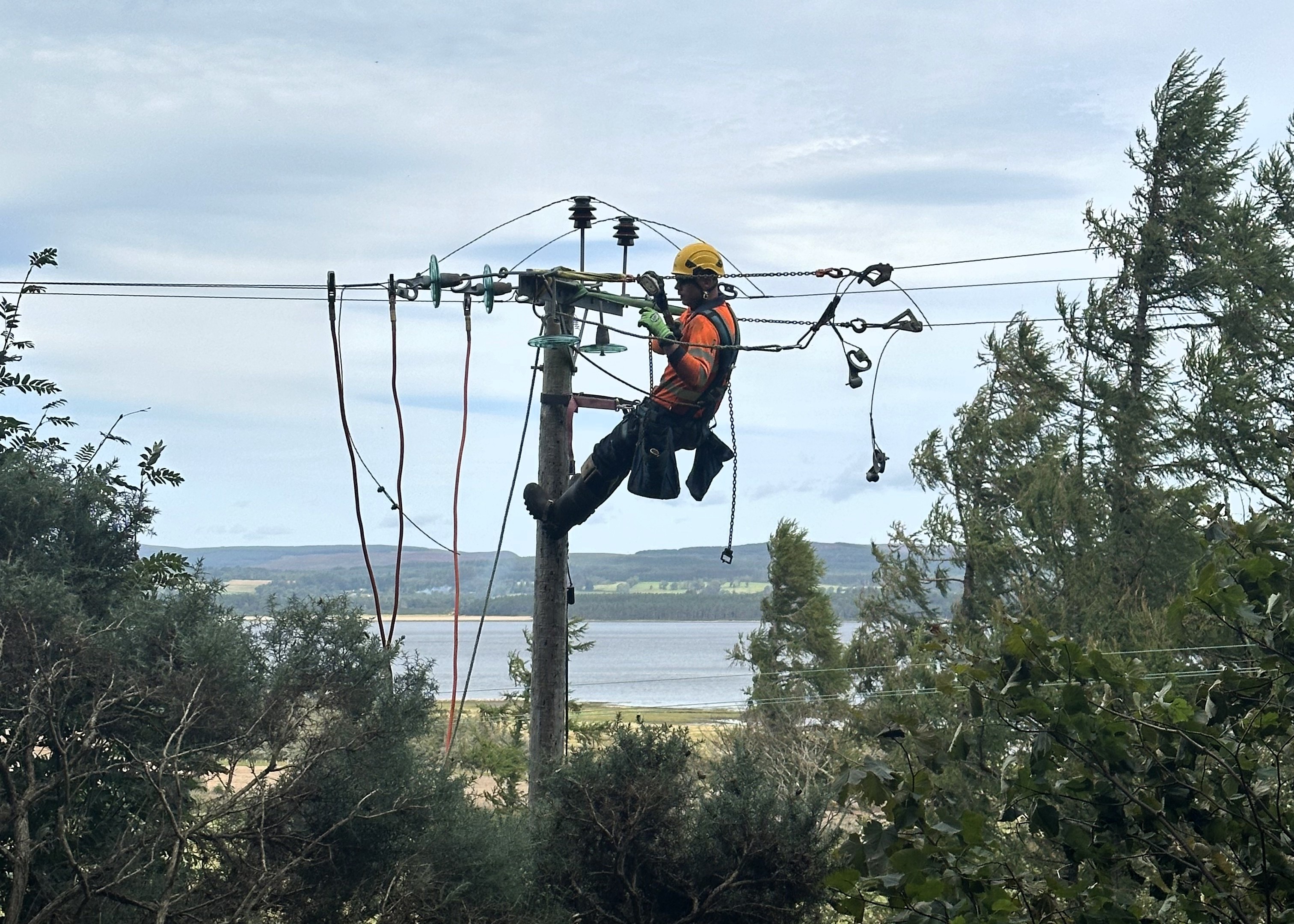 An engineer fixing the SSEN network at height