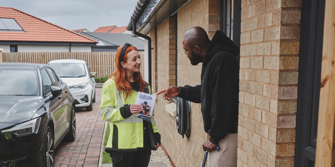 SSEN employee at customers door with PSR leaflet