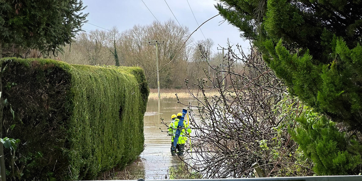 Engineers walking through flooding