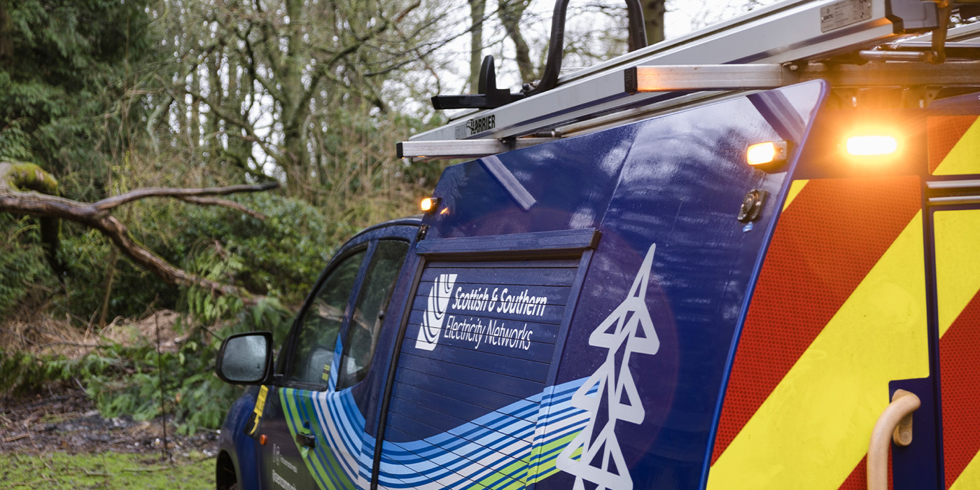 An SSEN Distribution vehicle in front of some storm damage