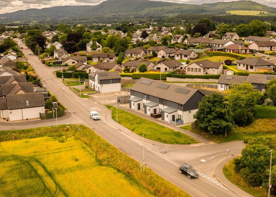 An aerial image of a small community showing houses with their own Distributed Energy Resources