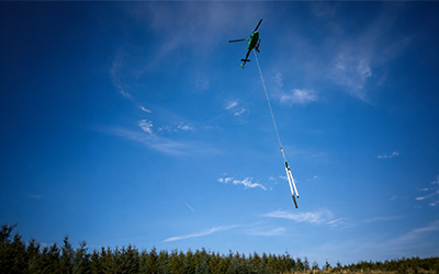 Helicopter carrying poles as part of Portree-Dunvegan network upgrade Aug 2026
