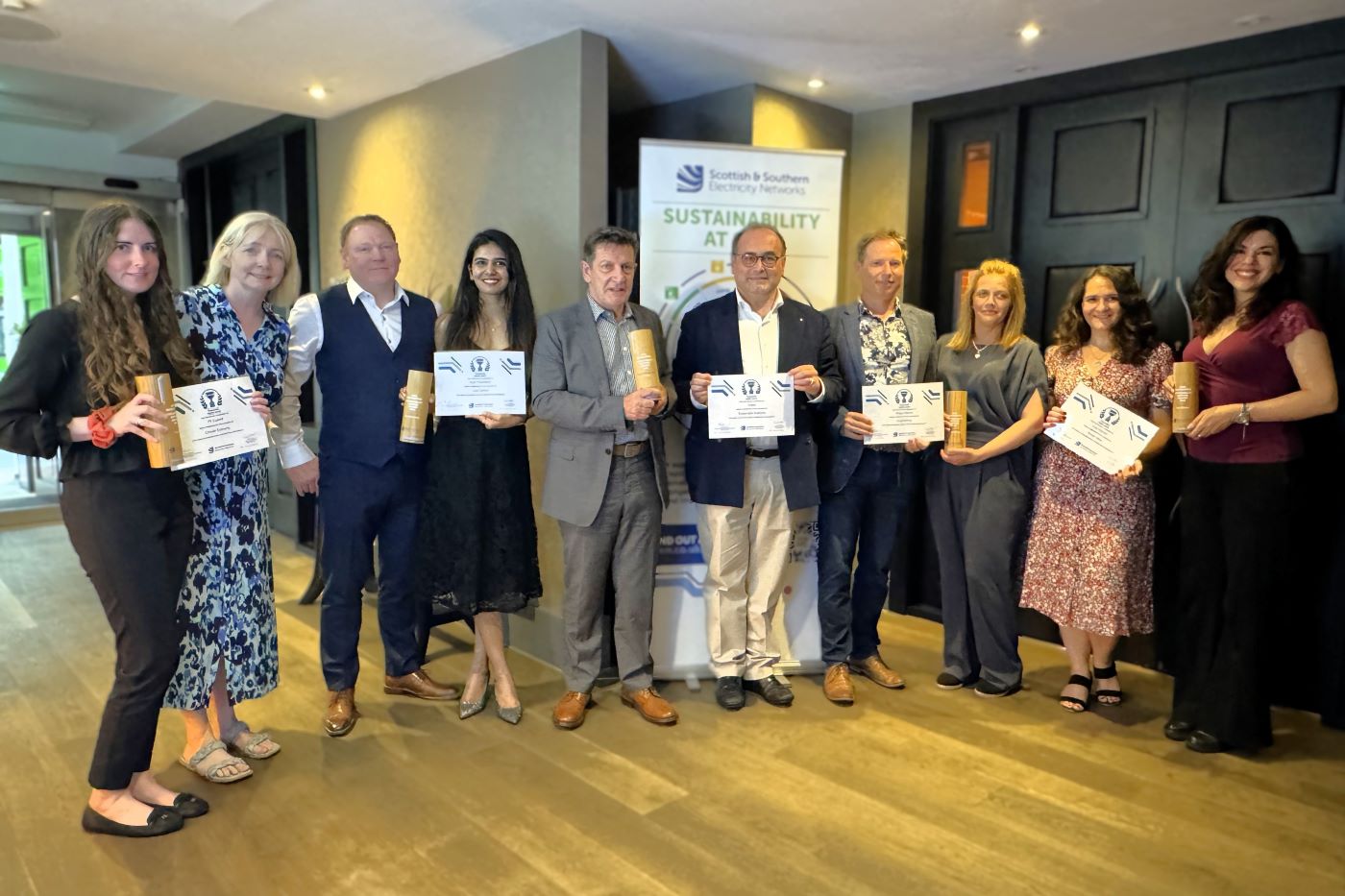 A picture of the 5 award winners standing with their certificates
