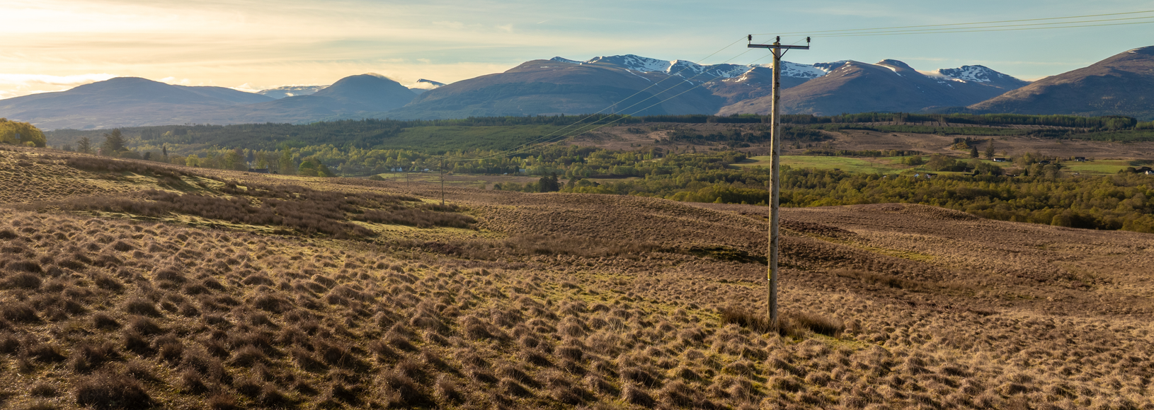 Image of landscape with electricity pole in the foreground